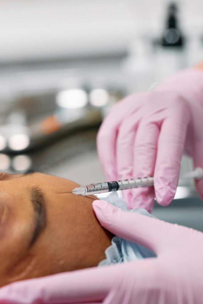 Detailed view of a cosmetic injection procedure being performed in a clinical setting.